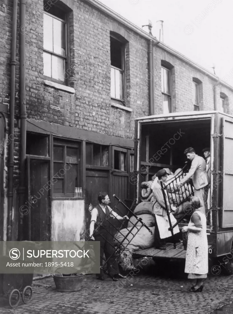 Home removals, c 1930s. Loading the bed into the removals van. Photograph by Reuben Saidman.