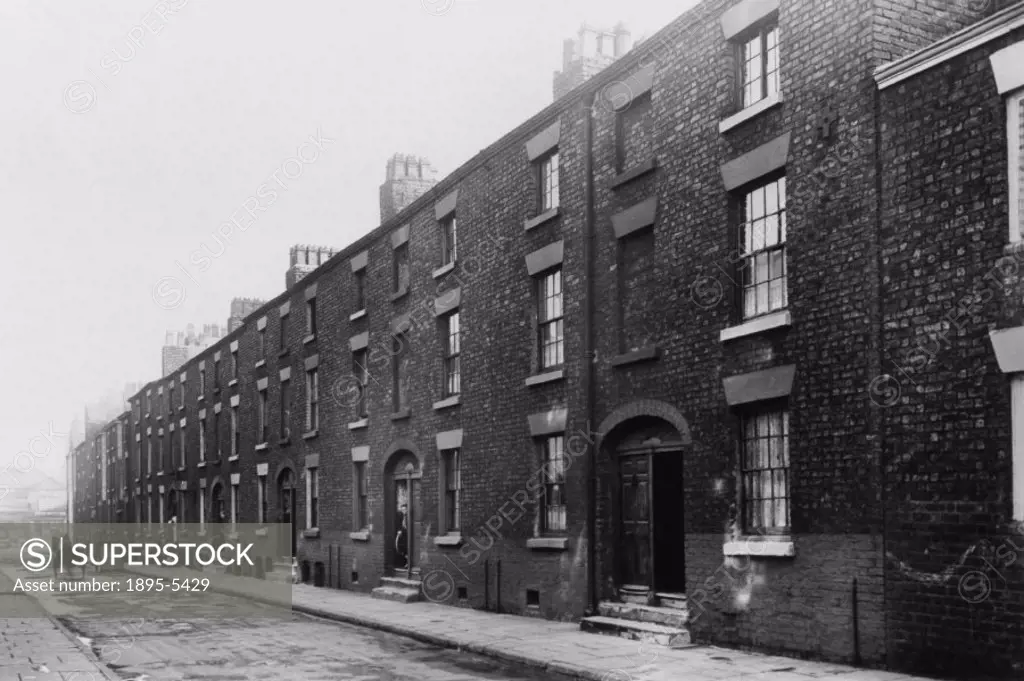 Photograph showing numbers 6 to 44 Torbock Street in Liverpool. ´Note how the Corporation neglect to repair the carriageway.´ POVERTYSLUMSTERRACED H...