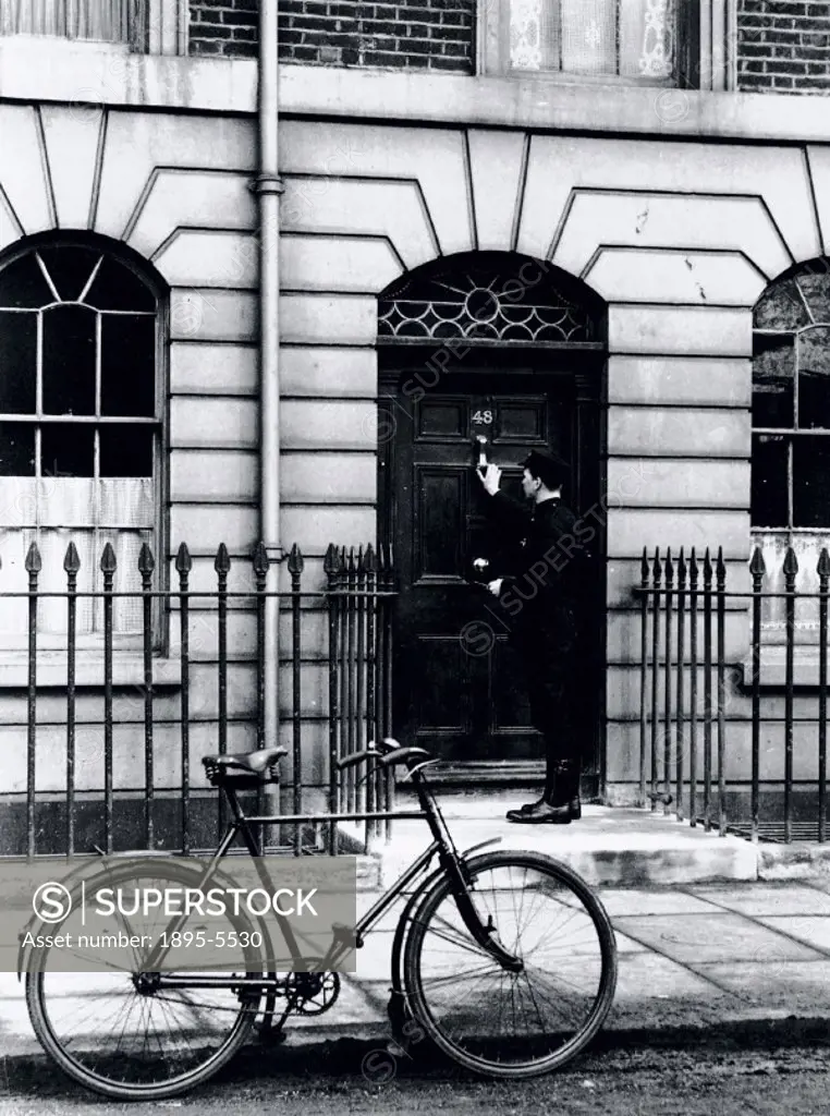 Postman delivering a telegram to an address in London, c 1930s.