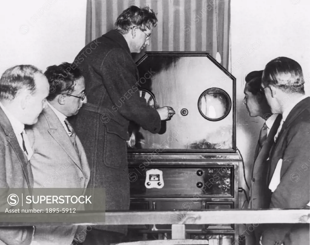 John Logie Baird (1888-1946) with his model C30 line televisor. After a serious illness in 1922, Baird devoted himself to experimentation and develope...