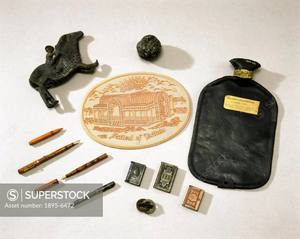 A selection of objects made out of early samples of natural and semi-synthetic rubber. Those from natural rubber include a Peruvian toy, a moulded pin...