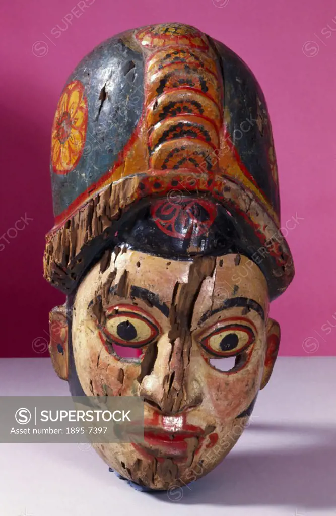 A polychrome wooden disease mask in the form of a human face worn for healing rituals. In some forms of traditional medicine, healing powers lie in pe...