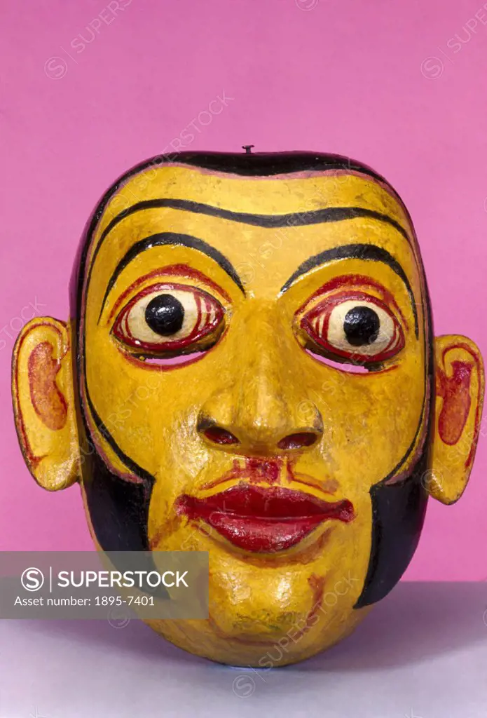 A polychrome wooden disease mask in the form of a human face, used for healing rituals. In some forms of traditional medicine, healing powers lie in p...