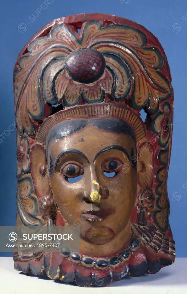 This polychrome wooden mask represents the Queen Bisava in the prelude to the kolam masked play, and was worn for healing rituals. In some forms of tr...