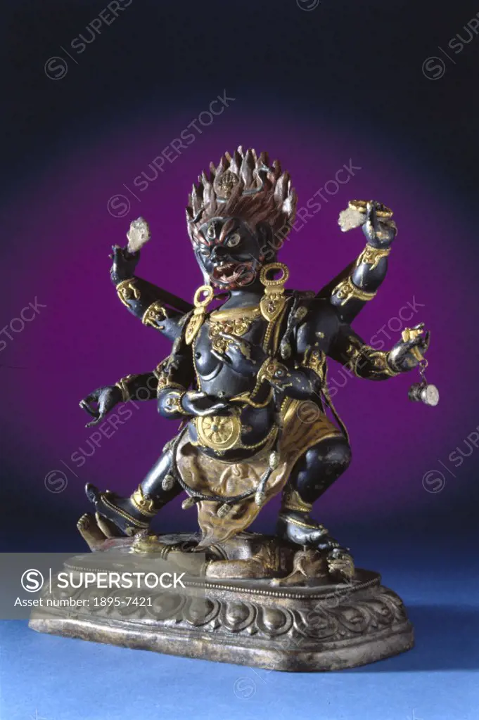 This lacquered brass and gilt statue depicts Mahakala, Protector of the Faith’, treading on the elephant god, Ganesh.