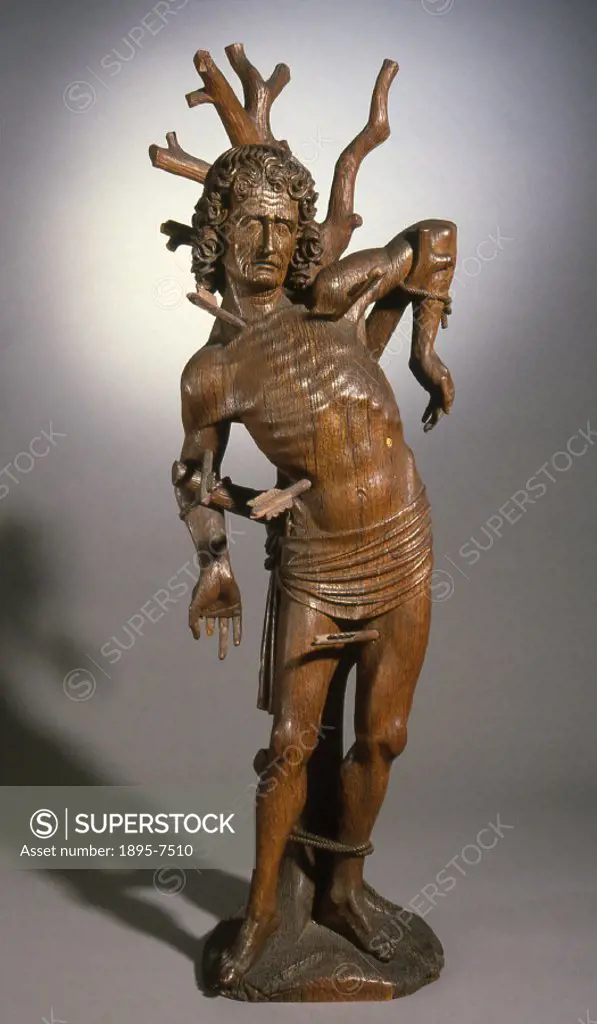 Oak statue of St Sebastian, patron saint of archers and soldiers. Sebastian was an officer of the Imperial Roman army, and captain of the guard under ...