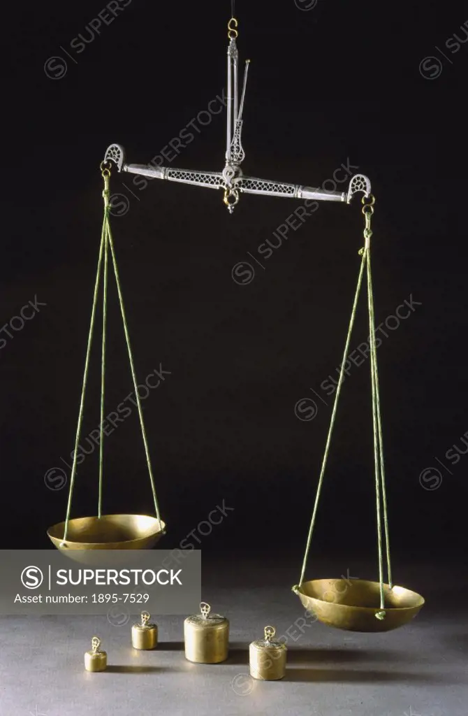 Set up for use, it is taken from a wooden chest containing three balances, a stand, weights, and accessories.