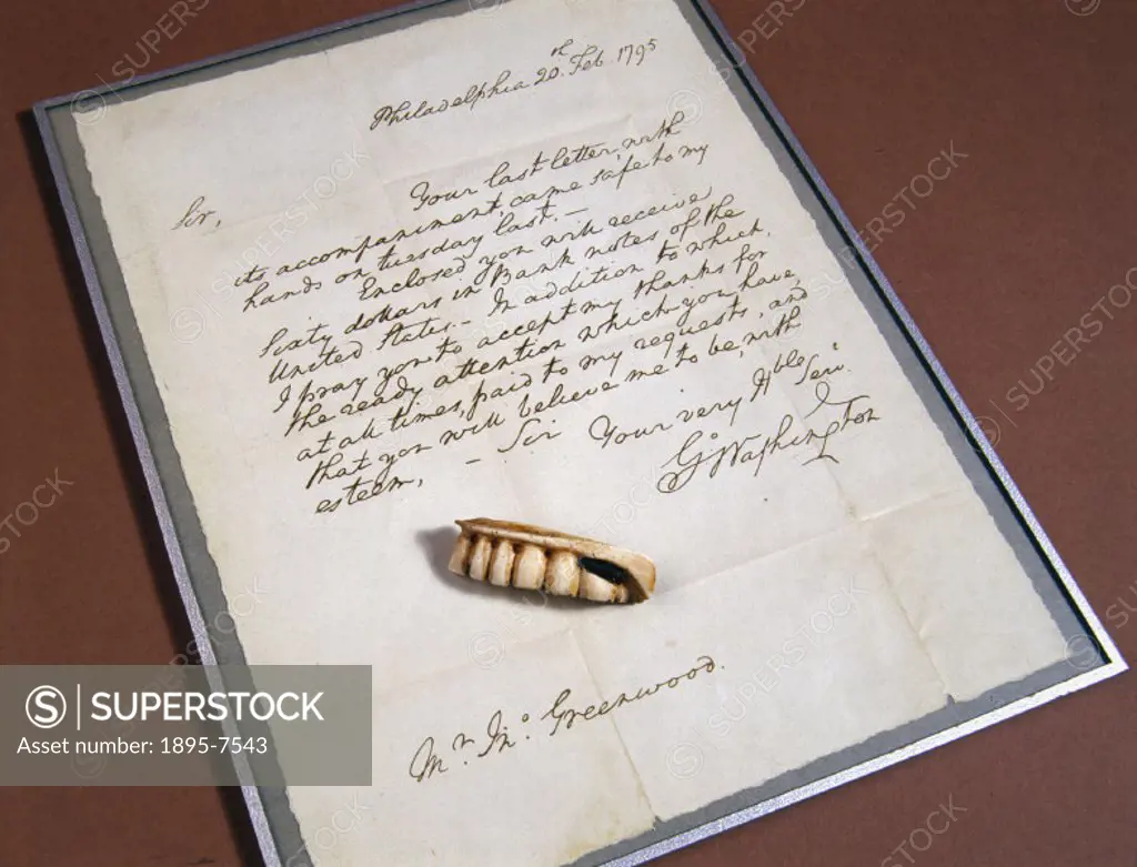 Replica of a set of dentures made for George Washington, President of the United States. The denture is shown with a copy of a letter written from him...