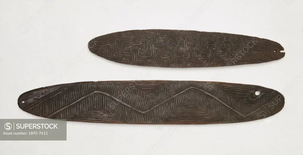 One of these Aboriginal artifacts is perforated at both ends, the other at one end. They are decorated with a carved, rectilinear design. Both are fro...