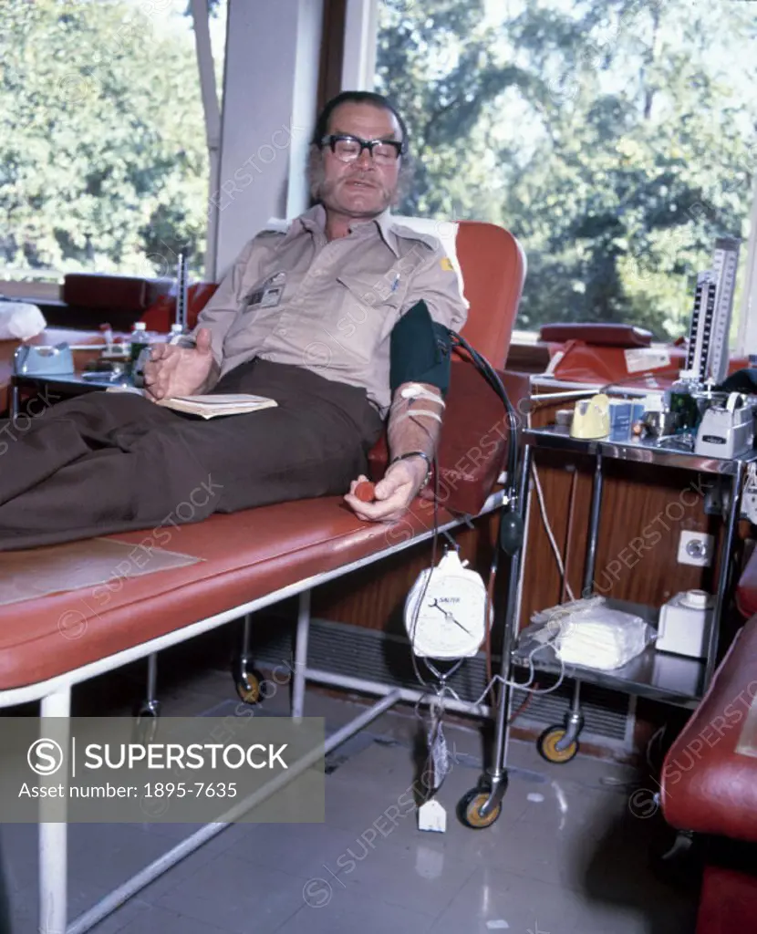 A man giving blood at the North London Blood Transfusion Centre.