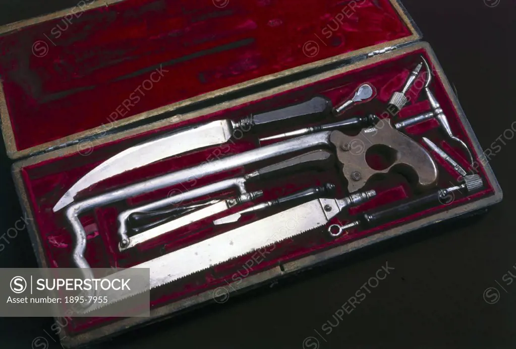 A set of surgical instruments, including knives and an amputation saw, in a case, together with a trade card.