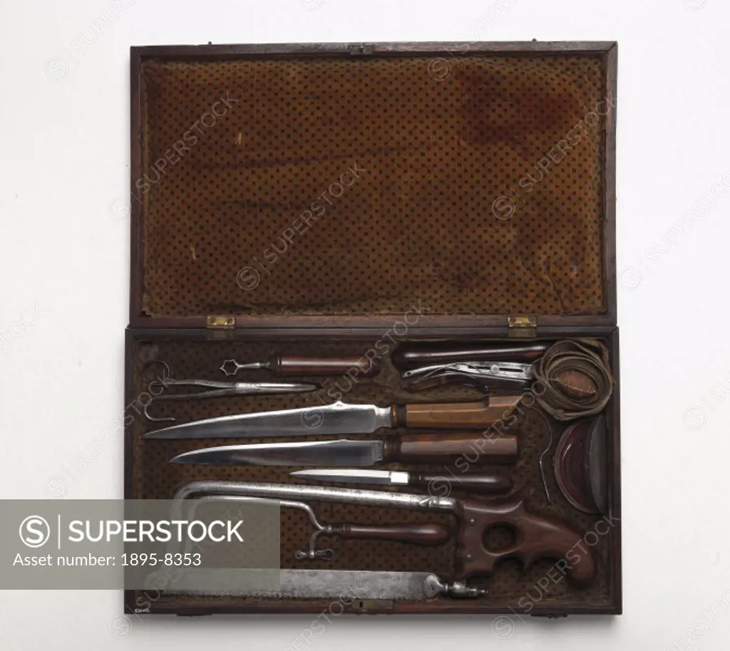 The case contains a wooden-handled field tourniquet, sutures, assorted knives (the small ones for cutting skin, the large ones for cutting muscle), a ...