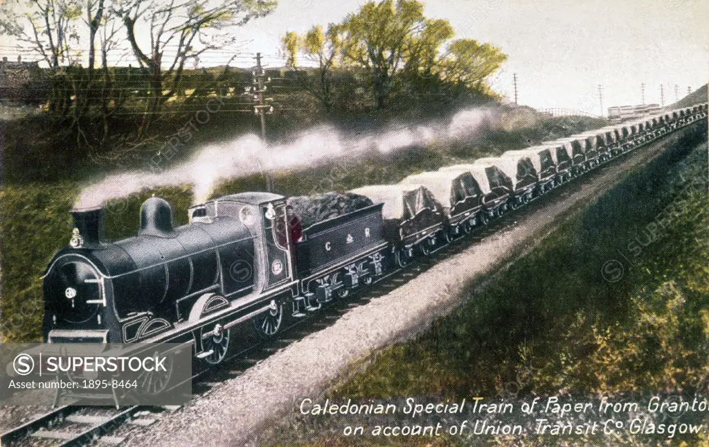 Postcard showing a Caledonian Railway 0-6-0 goods locomotive pulling a train of wagons loaded with paper.