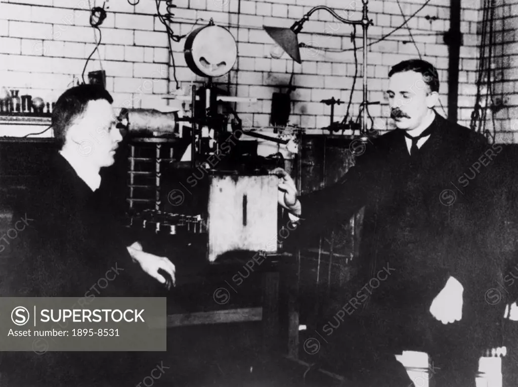 The New Zealand-British physicist Sir Ernest Rutherford (1871-1937) is pictured here with the German physicist Hans Geiger (1882-1945) with the appara...