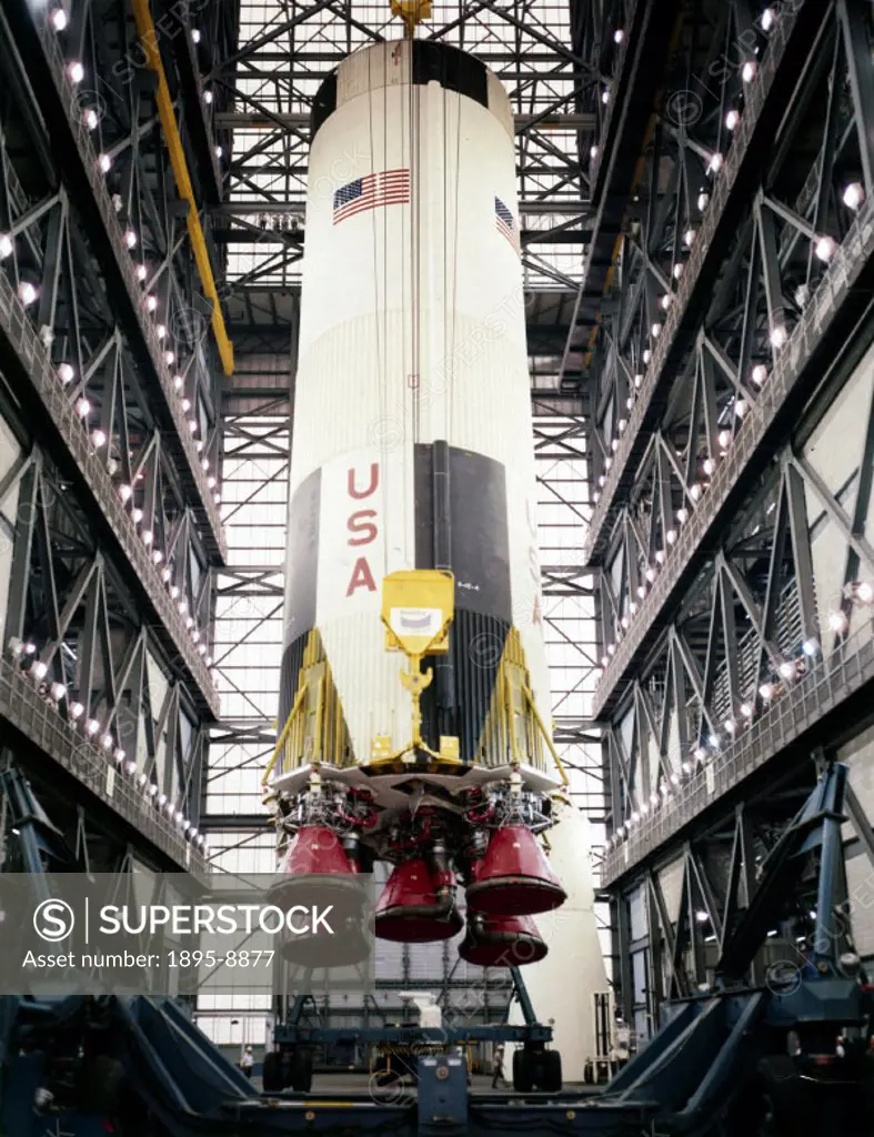 The first stage of a Saturn V being lowered into position in the Vehicle Assembly Building at the Kennedy Space Centre, Cape Canaveral, Florida. The u...