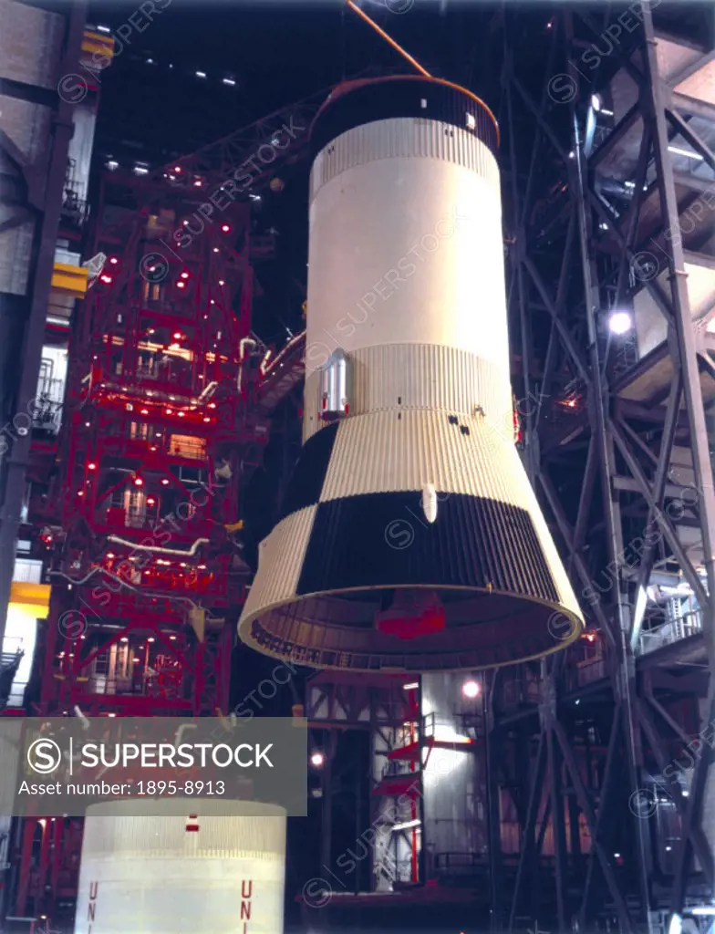 The third stage of the rocket is being raised in the Vehicle Assembly Building at the Kennedy Space Centre, Cape Canaveral, Florida, for mating with i...