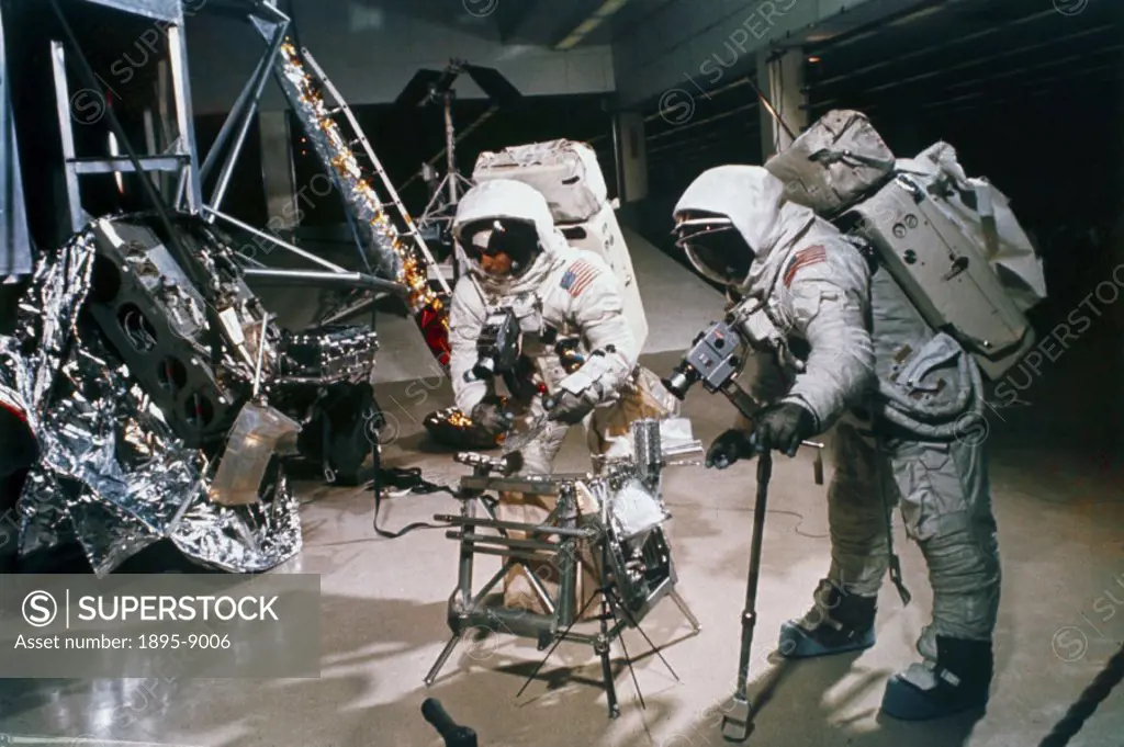 Astronauts Charles Conrad and Alan Bean, using the Apollo lunar hand tools in preparation for their mission. Apollo 12, the second manned lunar landin...