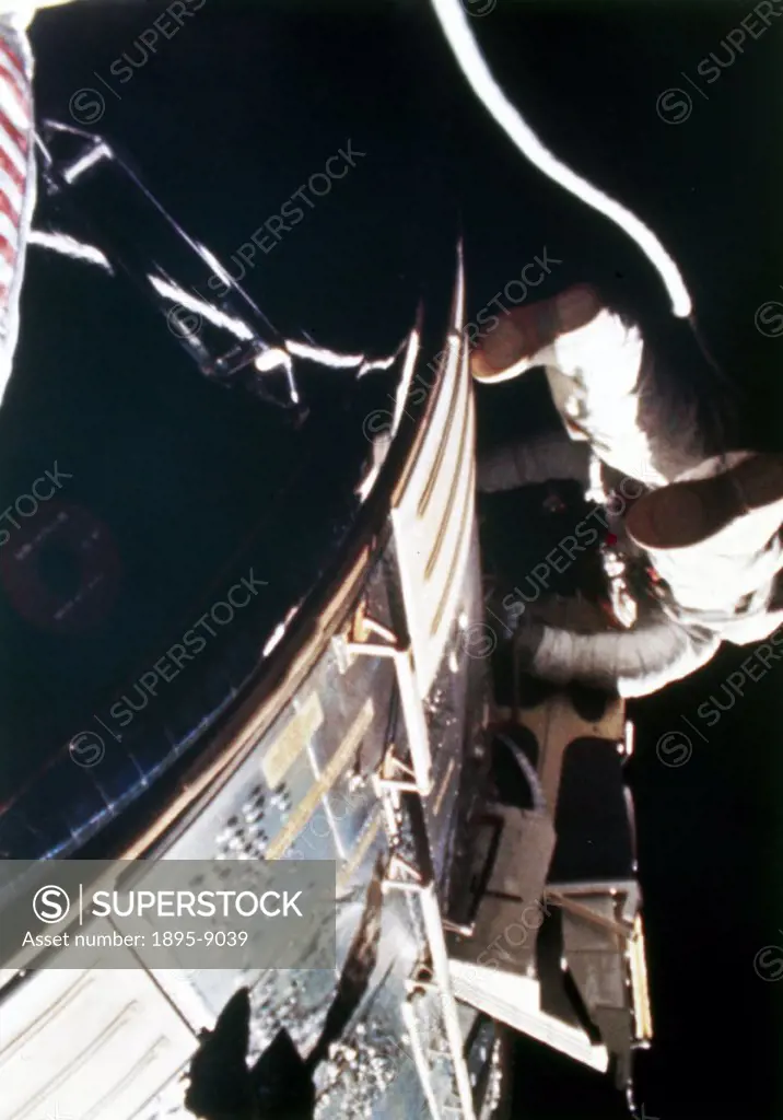 Worden, photographed from a camera mounted on the hatch of the Command Module, is retrieving films from the cameras in the SIM (Scientific Instrumenta...