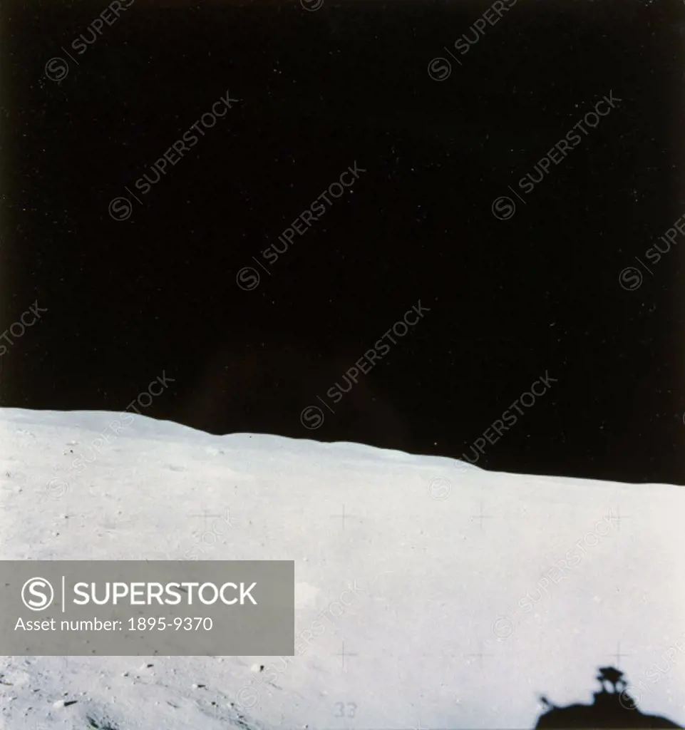 The shadow of the top of the Lunar Module can be seen at the bottom of the picture of the surface of the Moon, taken on one of the Apollo missions. NA...