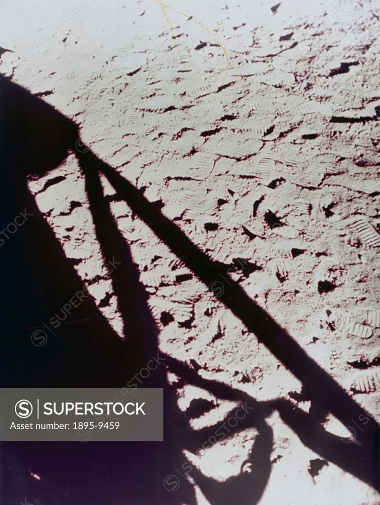 This picture taken from the cabin of the Lunar module shows the shadow of one if its legs on a lunar surface covered with astronauts footprints. NASA...