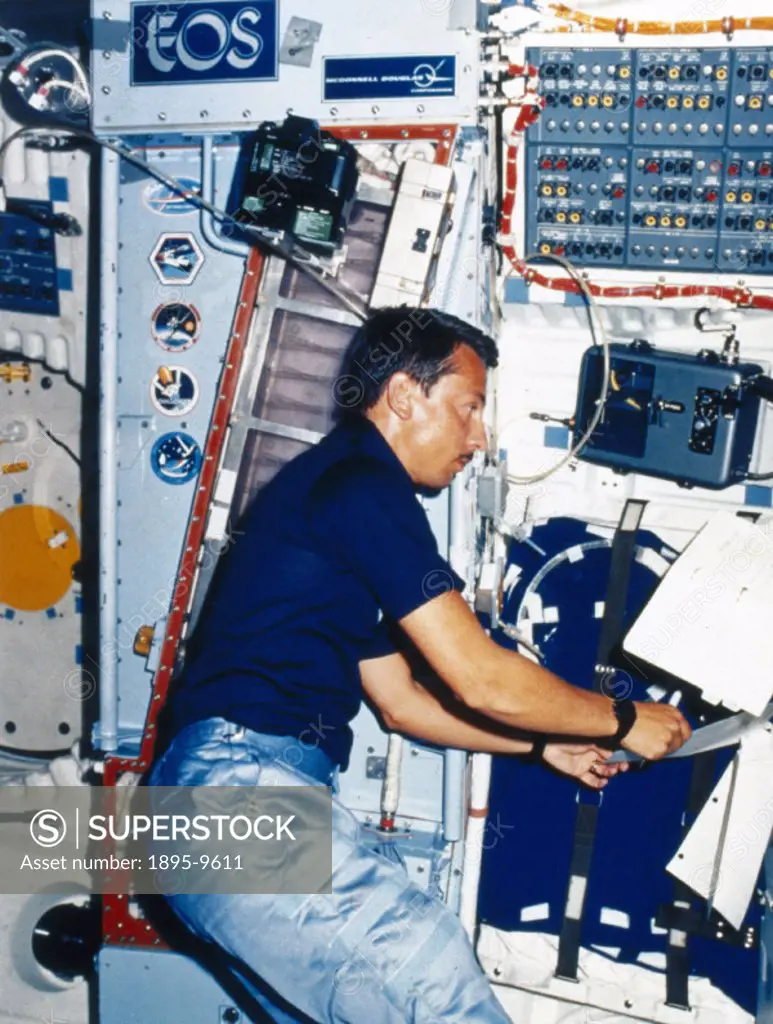 Astronaut Charles Walker on Space Shuttle Discovery Mission 51-A is conducting the McDonnell Douglas Electrophoresis Operations in Space (EOS) experim...