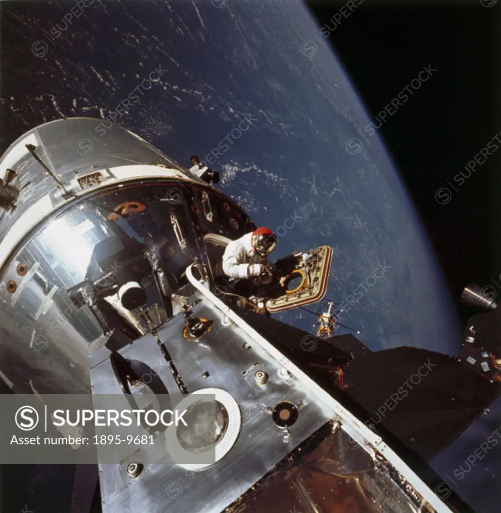 Scott was photographed by Russell Schweickart as he emerged from the hatch of the Apollo 9 Command Module in Earth orbit to undertake Extravehicular A...