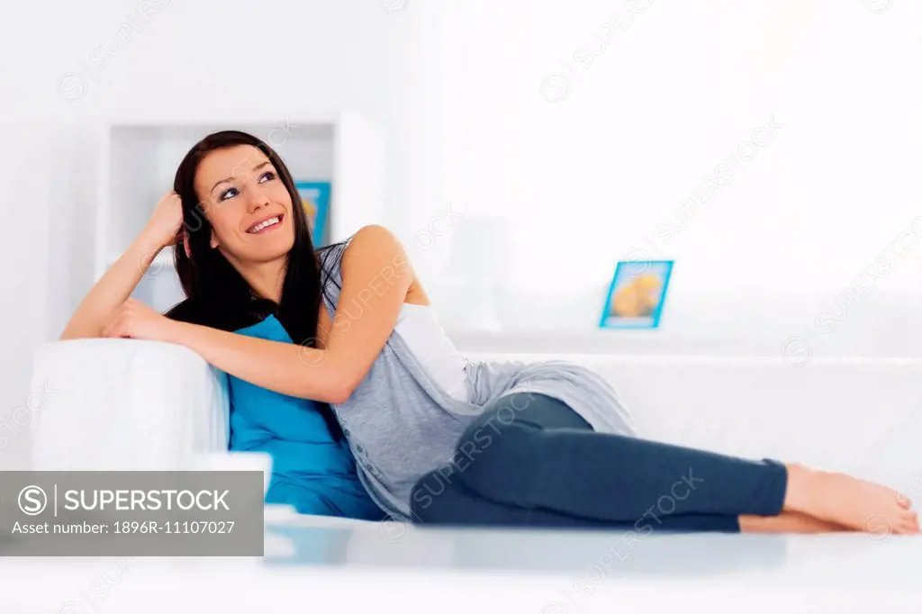 Young woman relaxation on sofa, Debica, Poland.