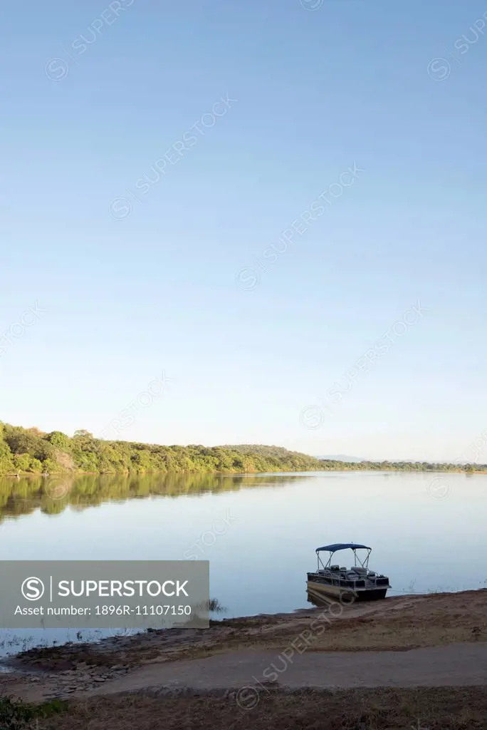A fishing boat moored on the bank of the Zambezi River.