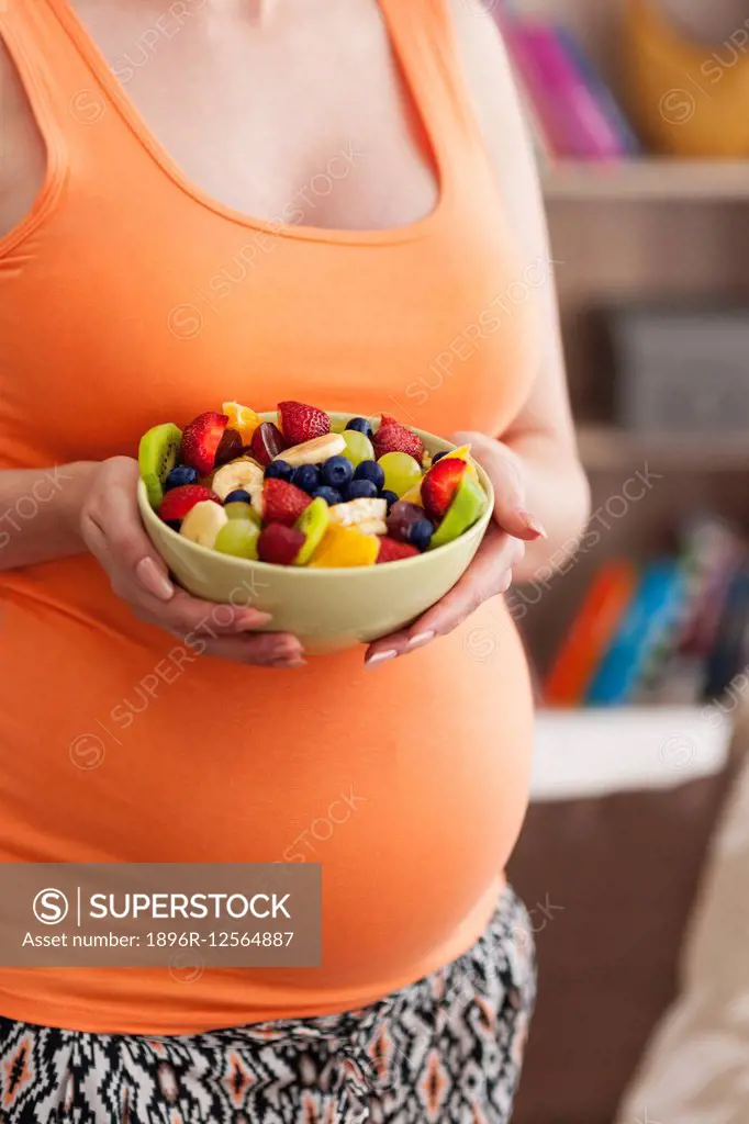 Close up of pregnant woman with fruit salad. Debica, Poland