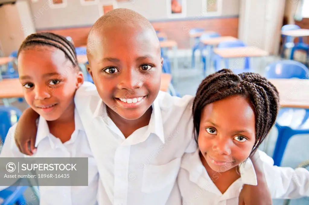 Portrait of three school children in classroom, Johannesburg, Gauteng Province, South Africa
