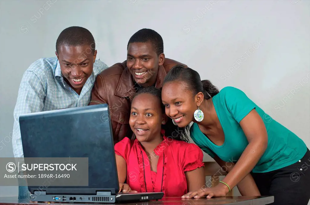 Kenyan students gathered around laptop, Nairobi, Kenya