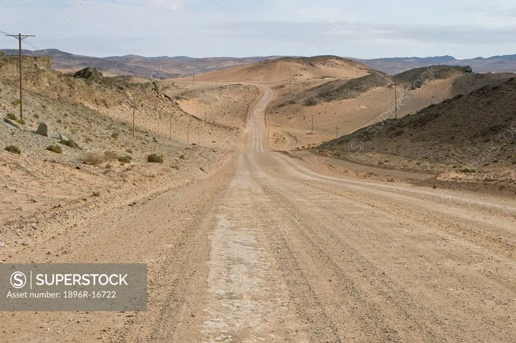 Gravel road running along Orange River and through diamond mining area, Northern Cape, South Africa