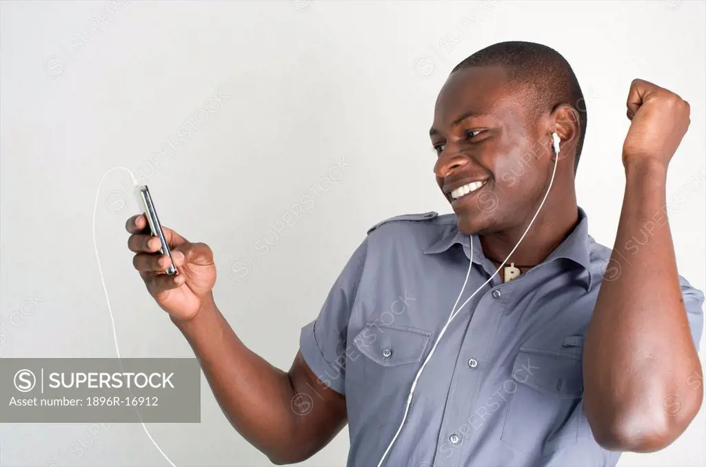 Young Kenyan man enjoying his iPod, Nairobi, Kenya