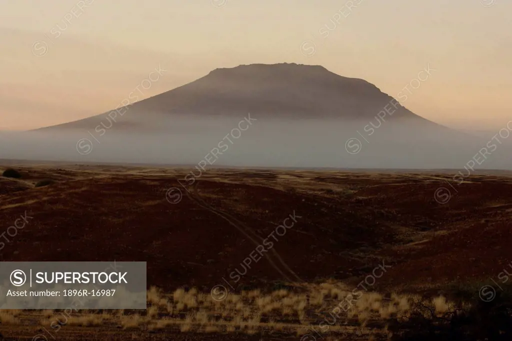 Mist hanging next to mountain, Namib Desert, Skeleton Coast, Namibia