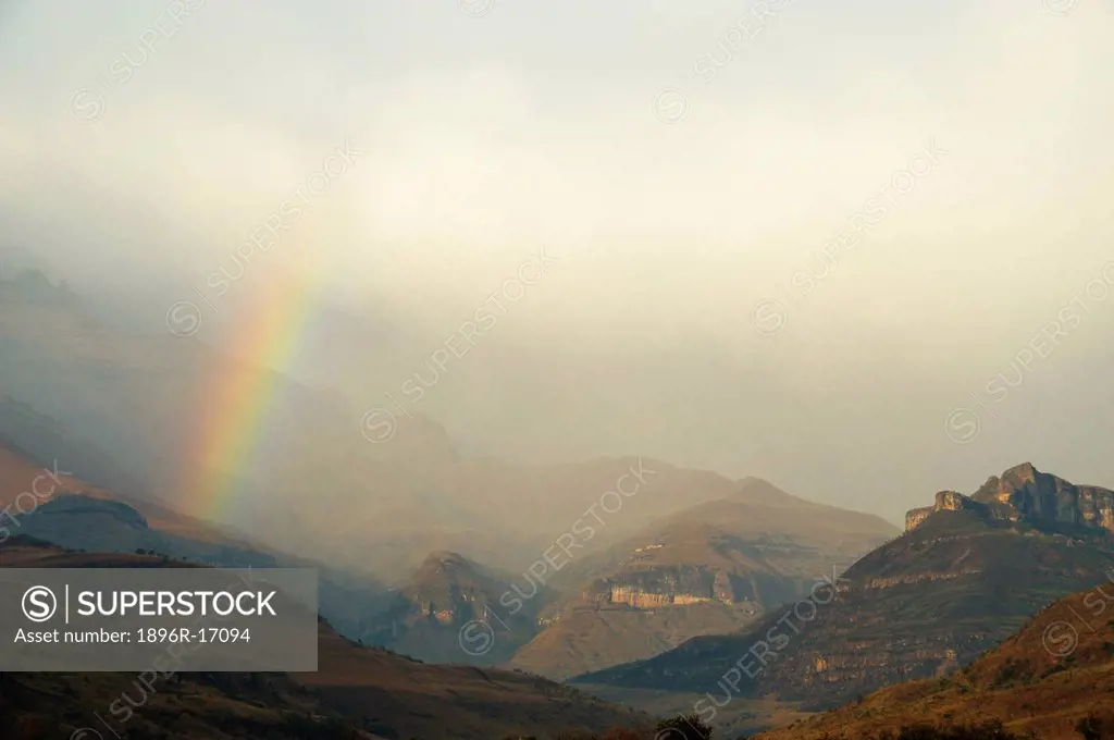 Rainbow at the base of the Amphitheatre range in the Drakensberg Mountains, Royal Natal, Kwazulu_Natal, South Africa