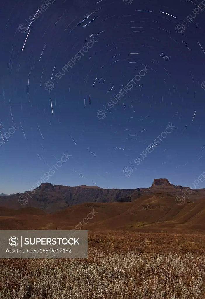 Star trails over the Amphitheatre range in the Drakensberg mountains, Kwazulu_Natal, South Africa