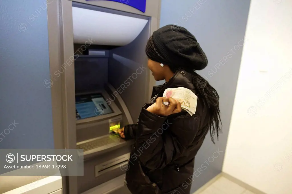 A young woman drawing money from the ATM, Pietermaritzburg, KwaZulu_Natal, South Africa