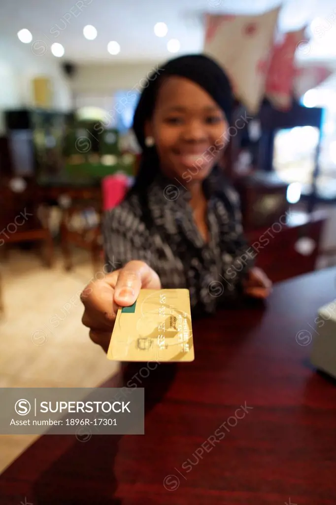 A young woman paying with her credit card, Pietermaritzburg, KwaZulu_Natal, South Africa