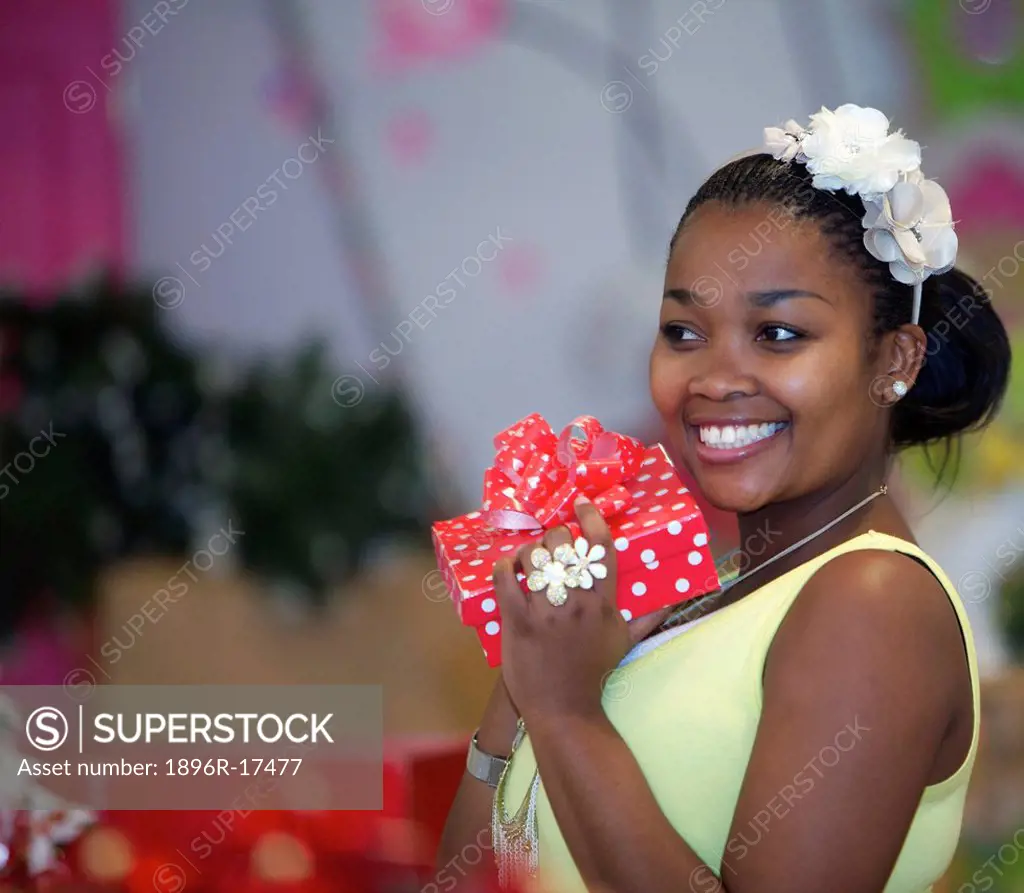 A young woman holding a present, Pietermaritzburg, KwaZulu_Natal, South Africa