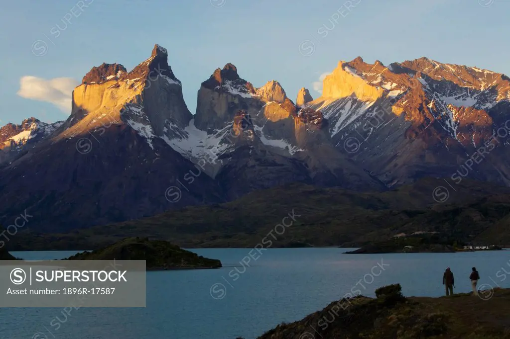Hikers admiring the last light on Cuernos del Paine, Torres del Paine National Park, Patagonia, Chile