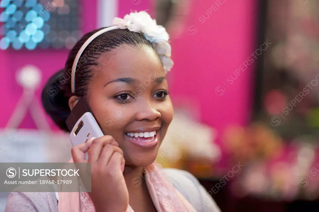A young woman using her cellphone, Pietermaritzburg, KwaZulu_Natal, South Africa