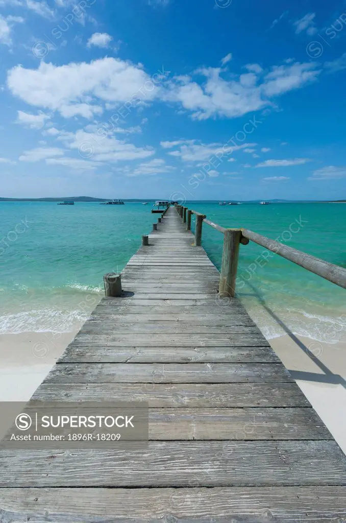 A long wooden jetty at Churchhaven in the West Coast national park disappears into the turquoise waters of the Langebaan Lagoon, Churchhaven, Western ...