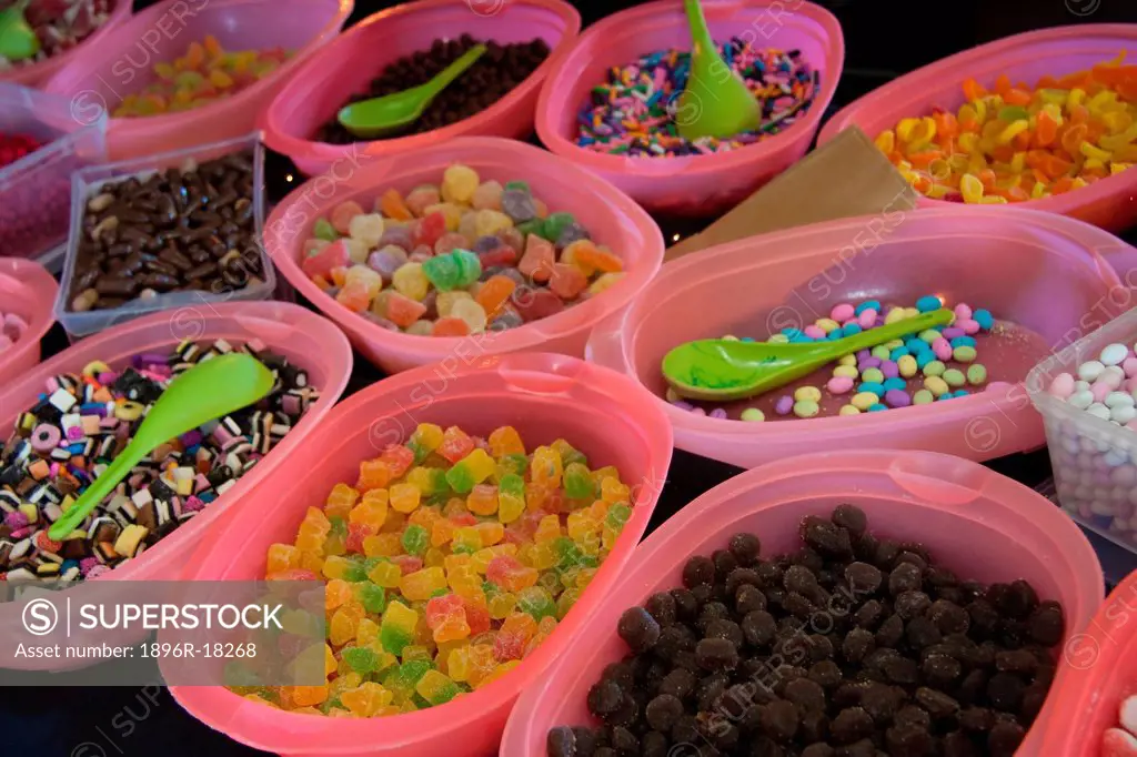 Bowls of multi_coloured sweets on display at stall in Mossel Bay, Western Cape, South Africa.