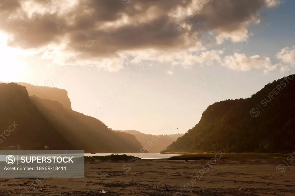 Low angle view of the Umzimvubu river mouth and surrounding gorge at sunset, Wild Coast, Port St John´s, Eastern Cape, South Africa