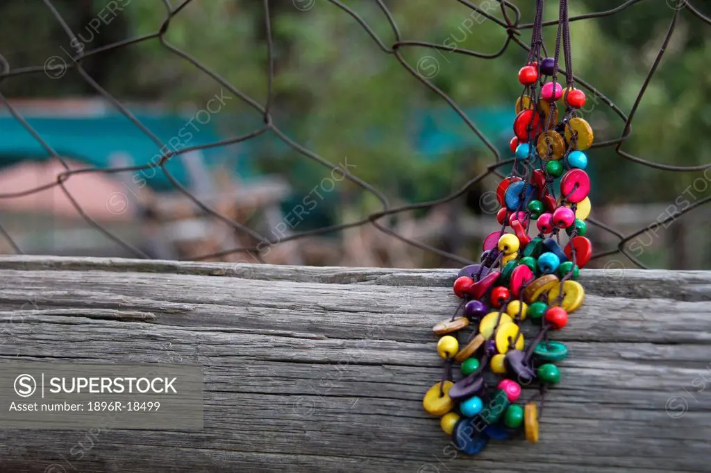Beaded Necklace hanging on a fence, Centurion, South Africa
