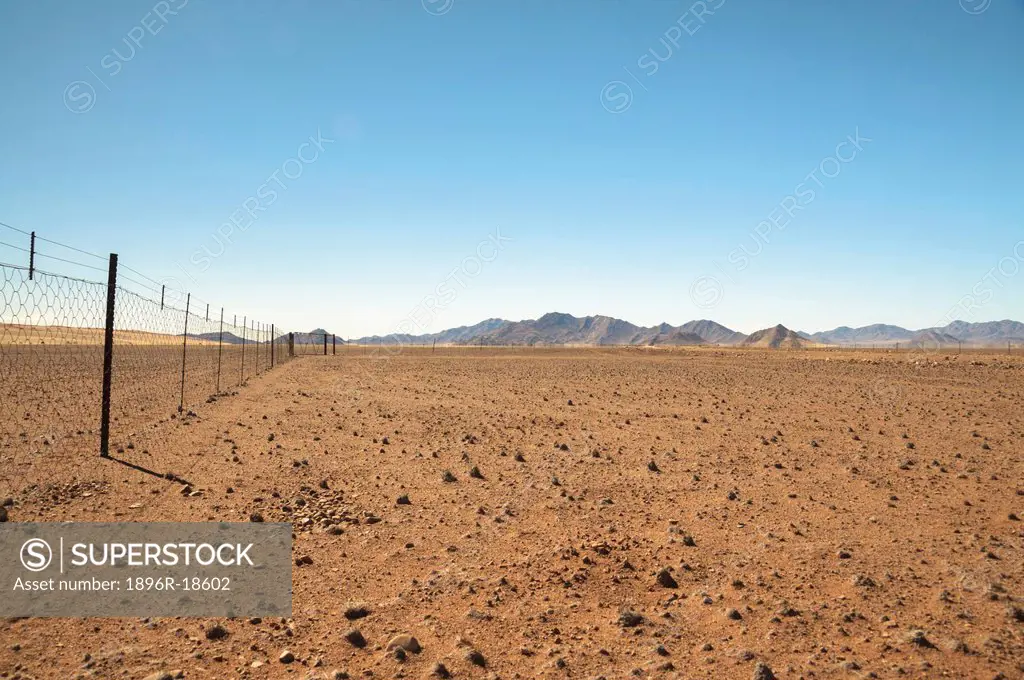 Barbed wire farm fence in desert, near Namib Desert, Karas Region, Namibia