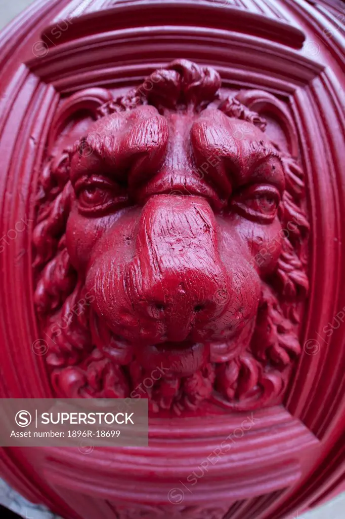 Close up of a red door knocker.