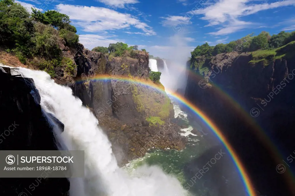 Wide angle view of a mist rainbow above the Victoria Falls Gorge. Victoria Falls, Zimbabwe