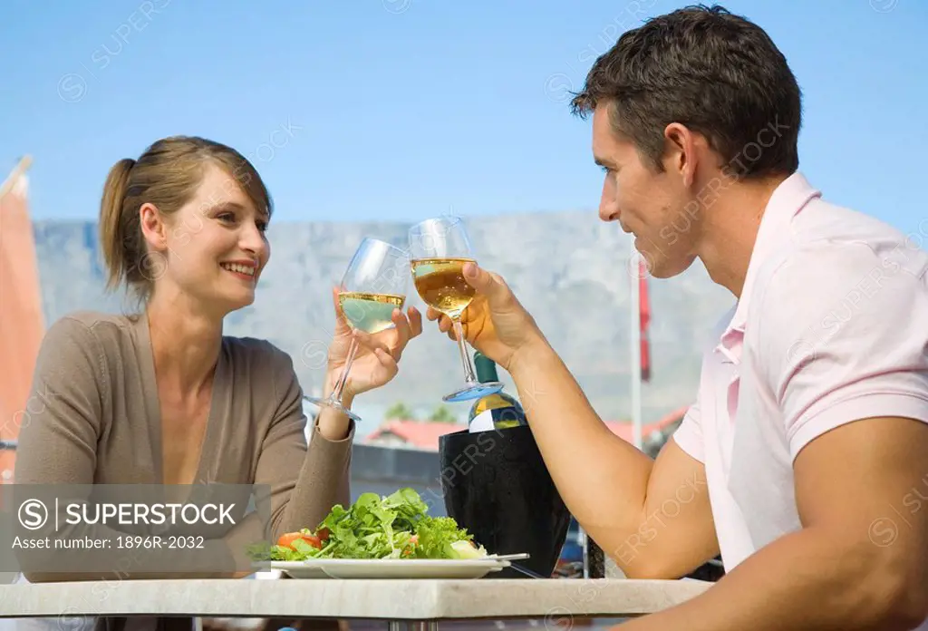 Couple enjoying a meal at the Waterfront with Table Mountain in background, Cape Town, Western Cape Province, South Africa