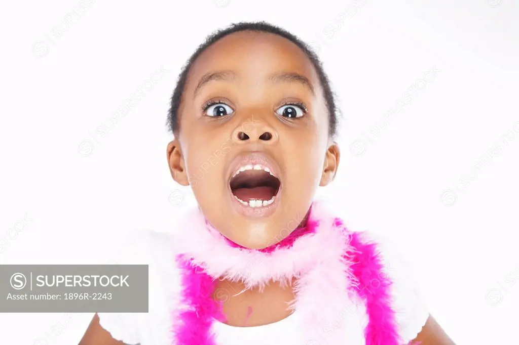 Young girl taking deep breath, mouth open